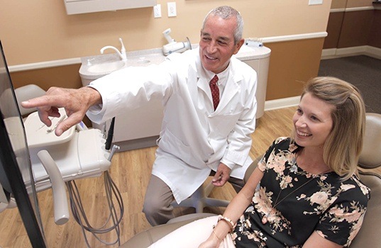 Dentist and patient looking at dental x-rays