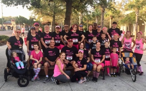 Dental team wearing pink at community event for breast cancer awareness