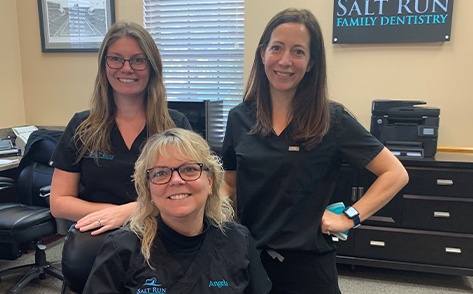 Three smiling dental team members at Salt Run Family Dentistry in Saint Augustine