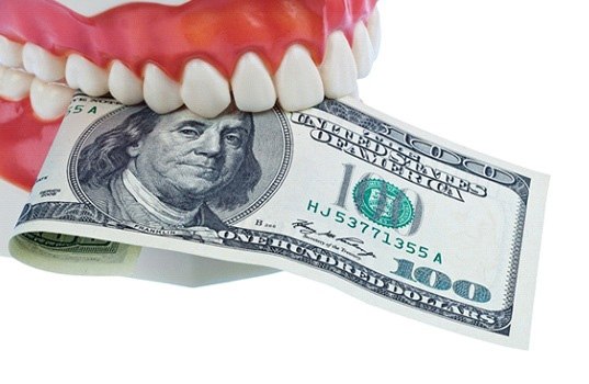 Denture biting money to represent cost