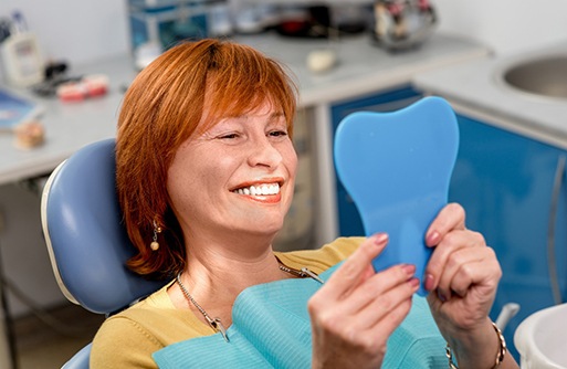An elderly woman enjoying her dentures