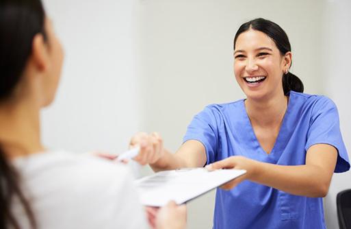 Dentist handing a patient their dental insurance summary