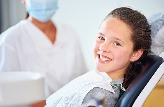 Child smiling after fluoride treatment