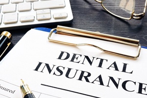 Dental insurance form on clipboard on desk