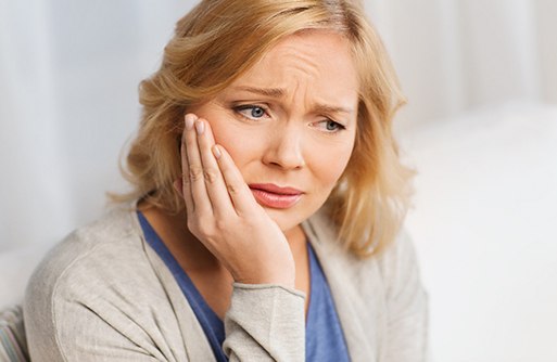 Concerned woman in need of dental implant salvage in St. Augustine
