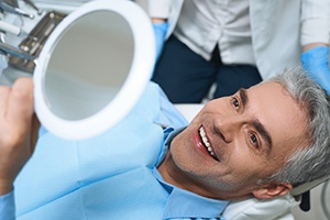 Man admiring his new dental implants in St. Augustine 