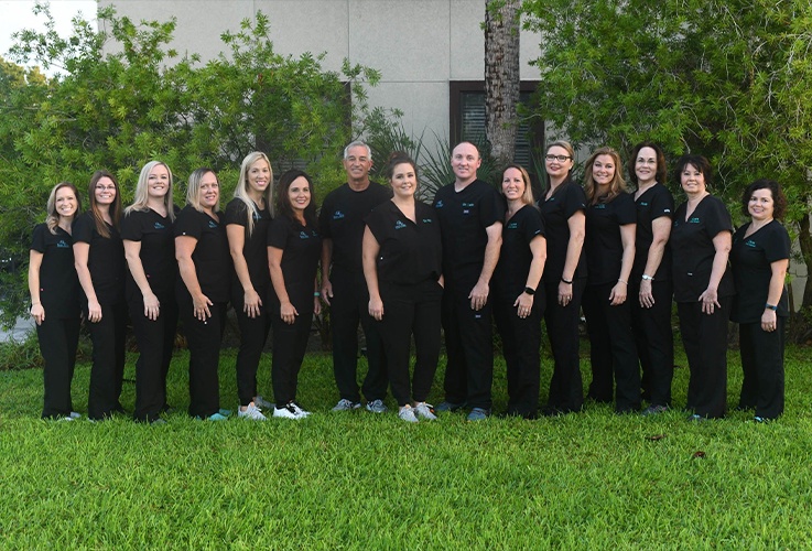 The Salt Run Family Dentistry team posing together outside of Saint Augustine dental office building