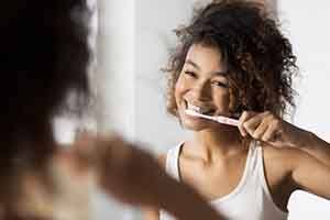 Invisalign Patient in St. Augustine brushing their teeth