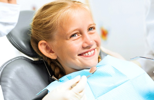 Young girl smiling in dental chair