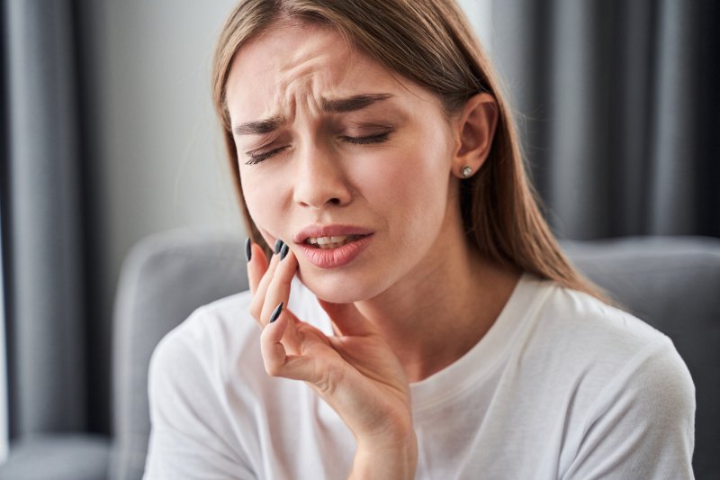 young woman experiencing dental emergency