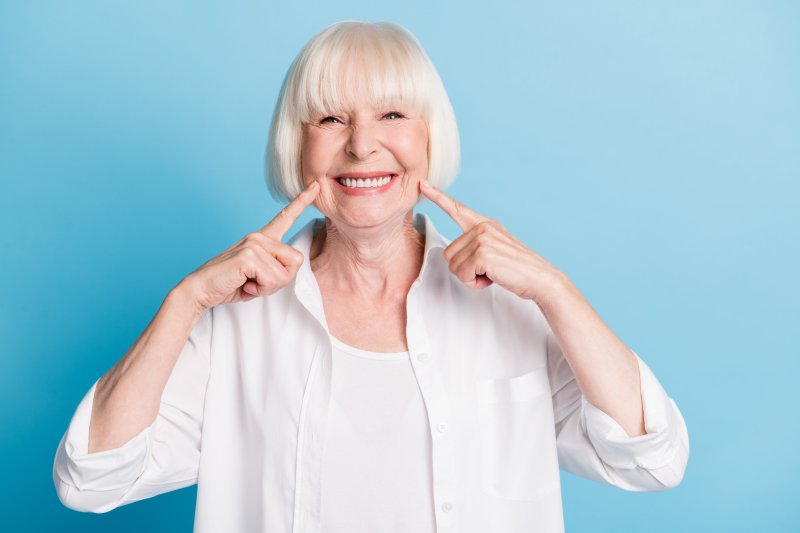 An older woman smiling with her stain-free dentures