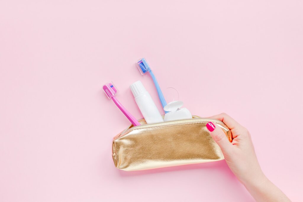 Patient holding gold bag with dental hygiene tools