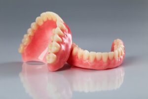Pair of dentures against a gray background